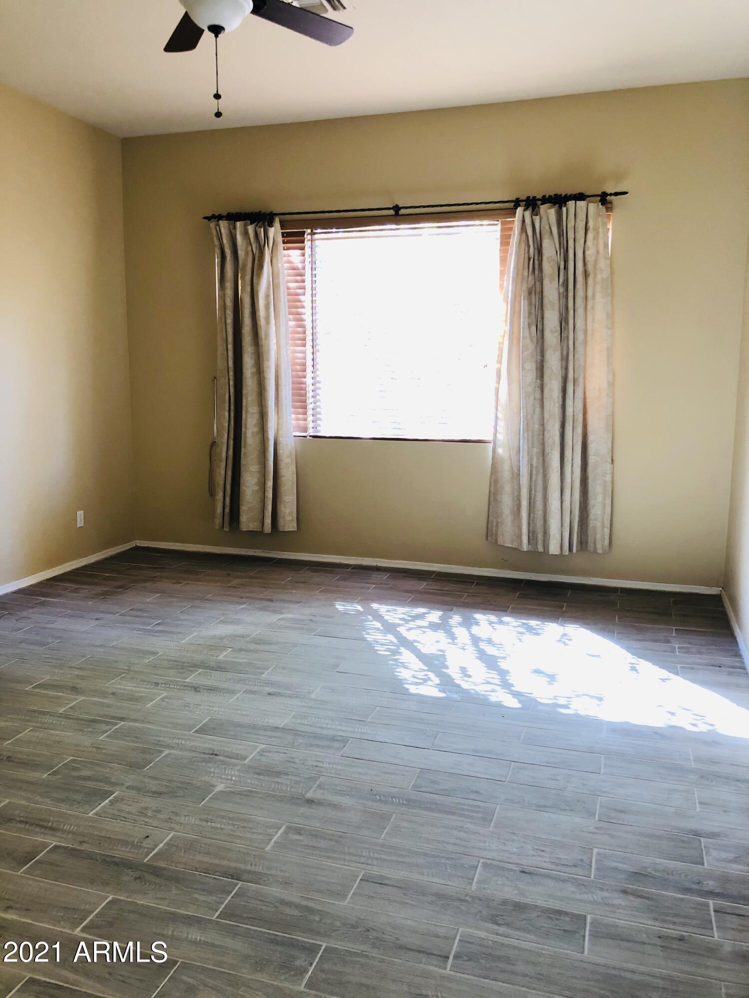 10453 East Pine Valley Drive Scottsdale, AZ 85255 - Photo 16 of 35 a view of a room with wooden floor and a window
