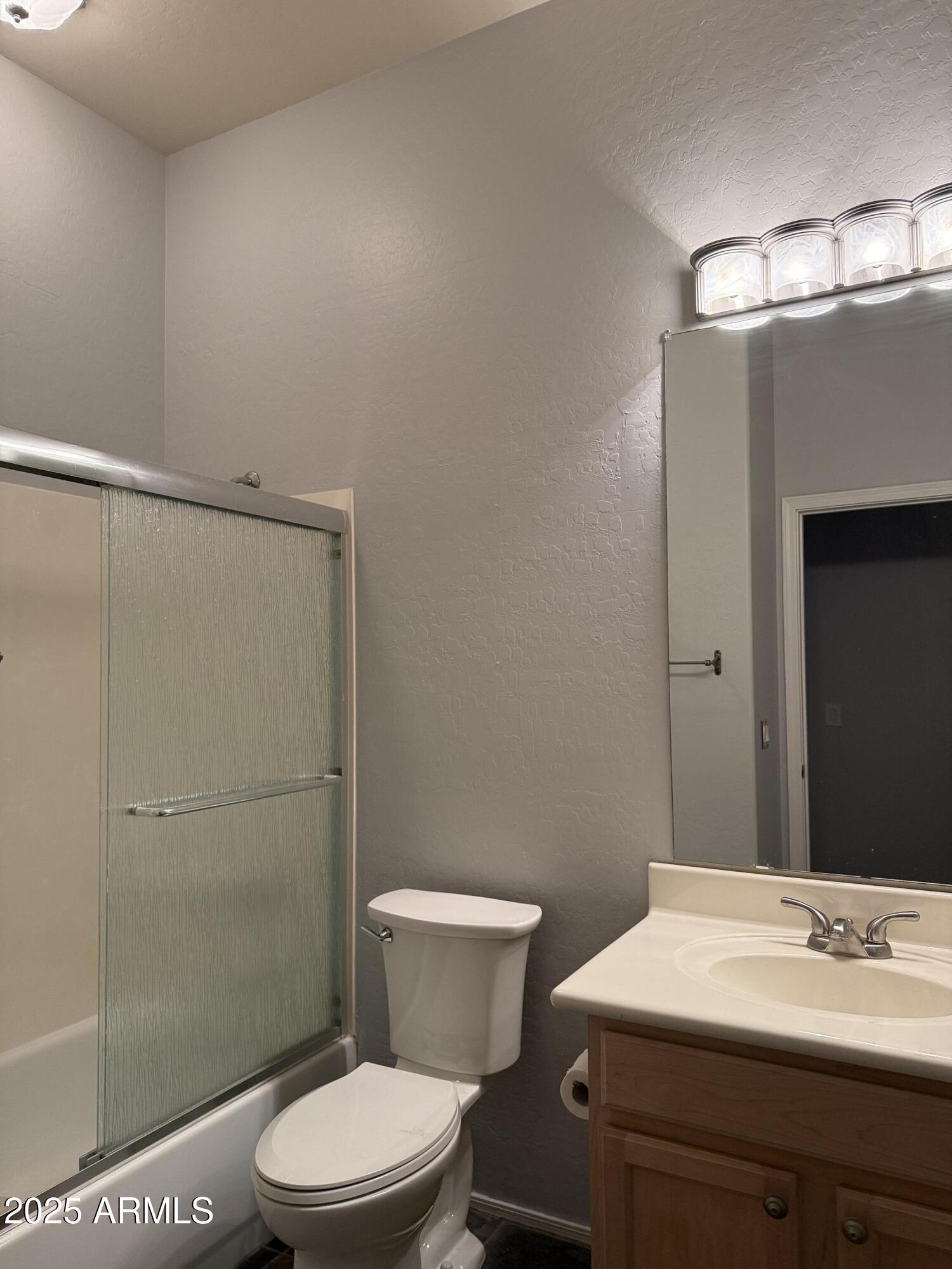 10453 East Pine Valley Drive Scottsdale, AZ 85255 - Photo 29 of 35 a bathroom with a sink a toilet a shower and a mirror