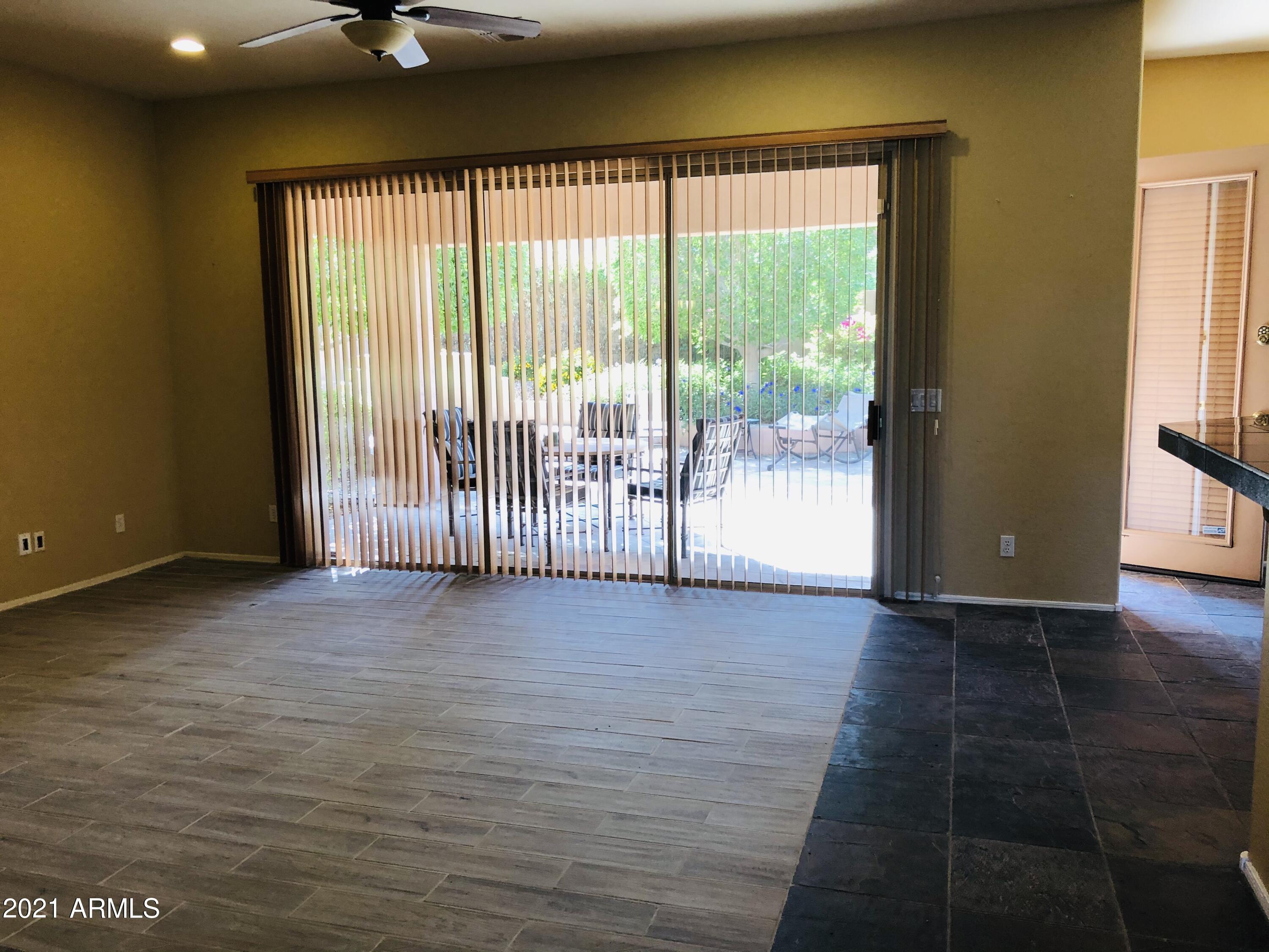 10453 East Pine Valley Drive Scottsdale, AZ 85255 - Photo 3 of 35 a view of a room with wooden floor and windows