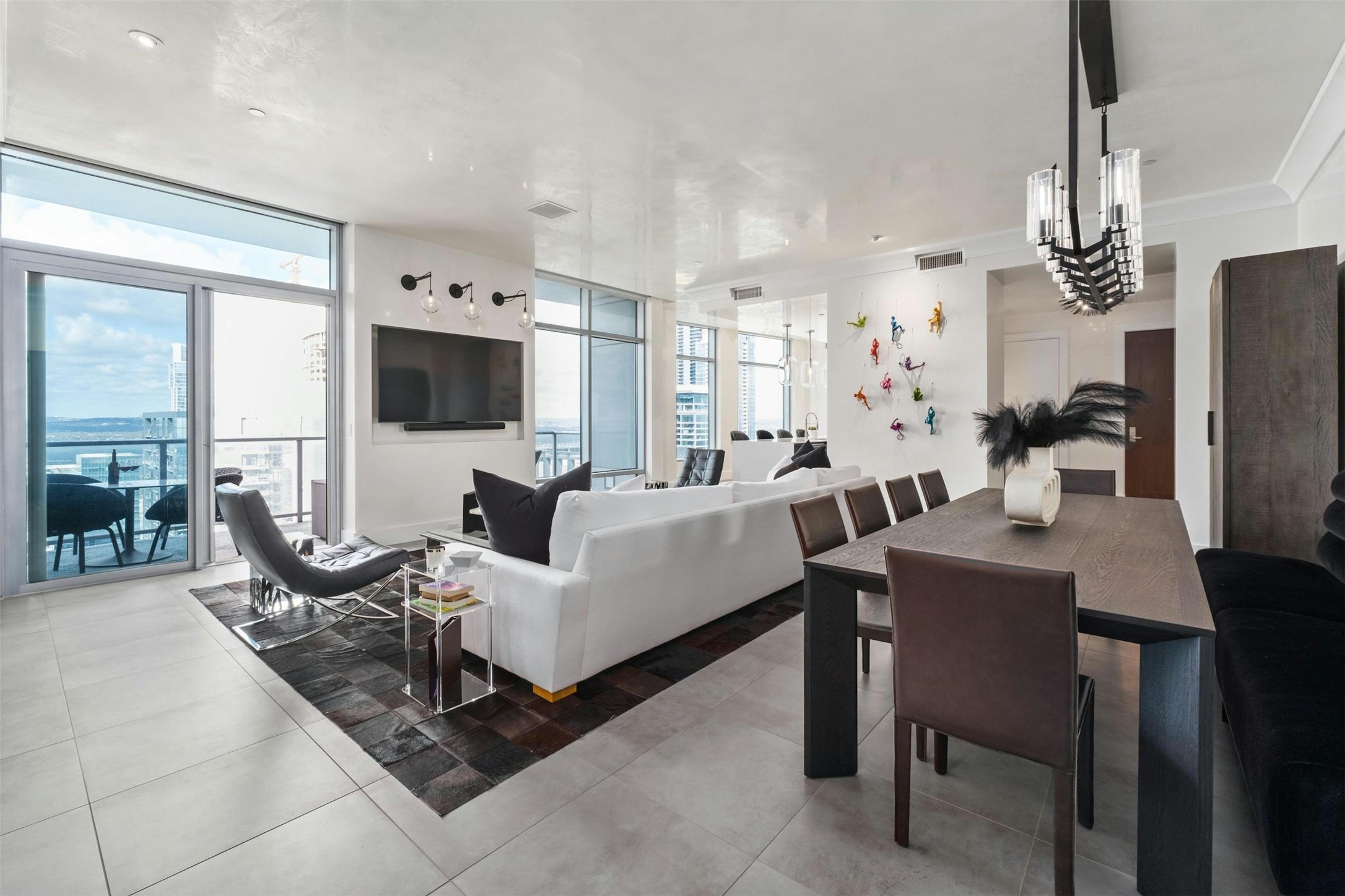 200 Congress Avenue, Unit 41Q Austin, TX 78701 - Photo 9 of 39 a living room with furniture a flat screen tv and a refrigerator