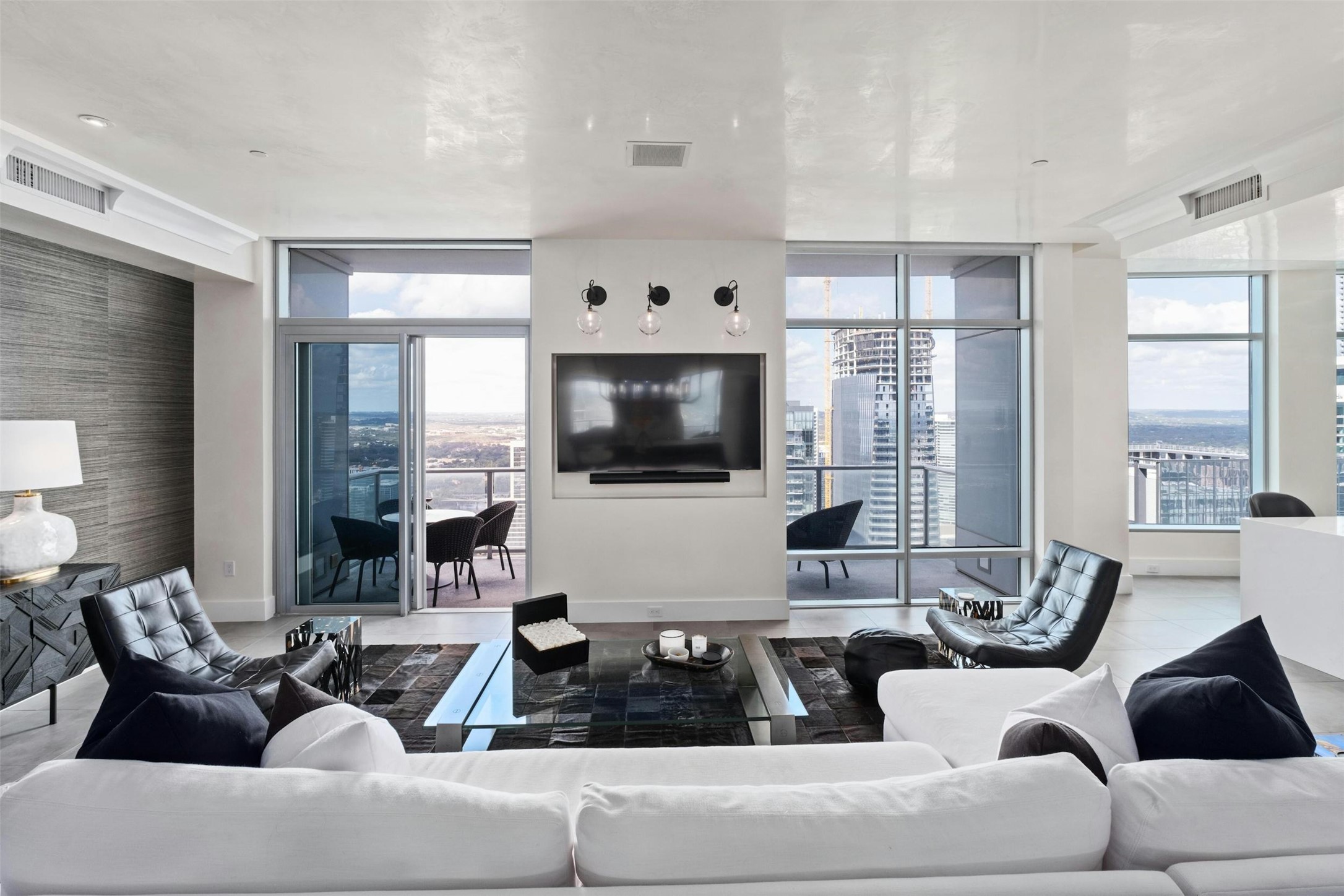 200 Congress Avenue, Unit 41Q Austin, TX 78701 - Photo 10 of 39 a living room with furniture and a flat screen tv