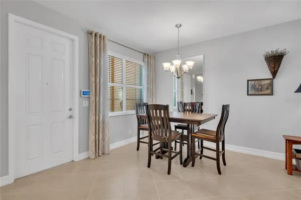 a dining room with furniture and window