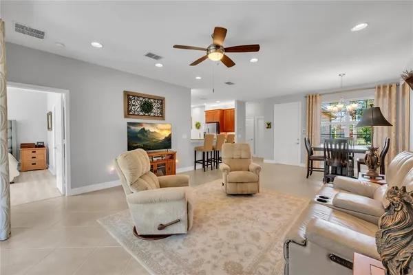 a living room with furniture and a view of kitchen