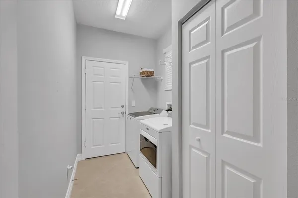 a hallway with washer and dryer