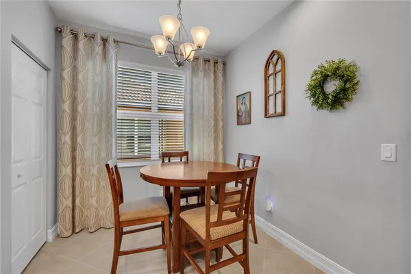 a view of a dining room with furniture and chandelier