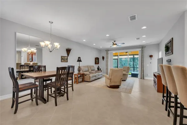 a kitchen and a dining table with chairs