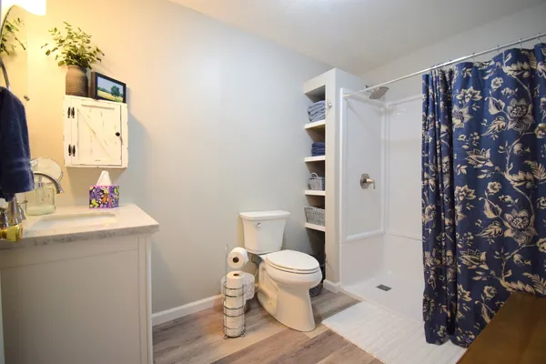 a bathroom with a sink toilet and shower