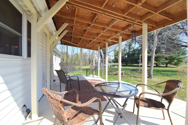 a patio with yard glass top table and chairs