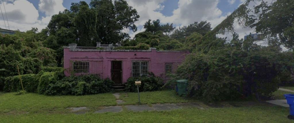 660 Northwest 43rd Street Miami, FL 33127 - Photo 1 of 5 a view of a big yard in front of a house