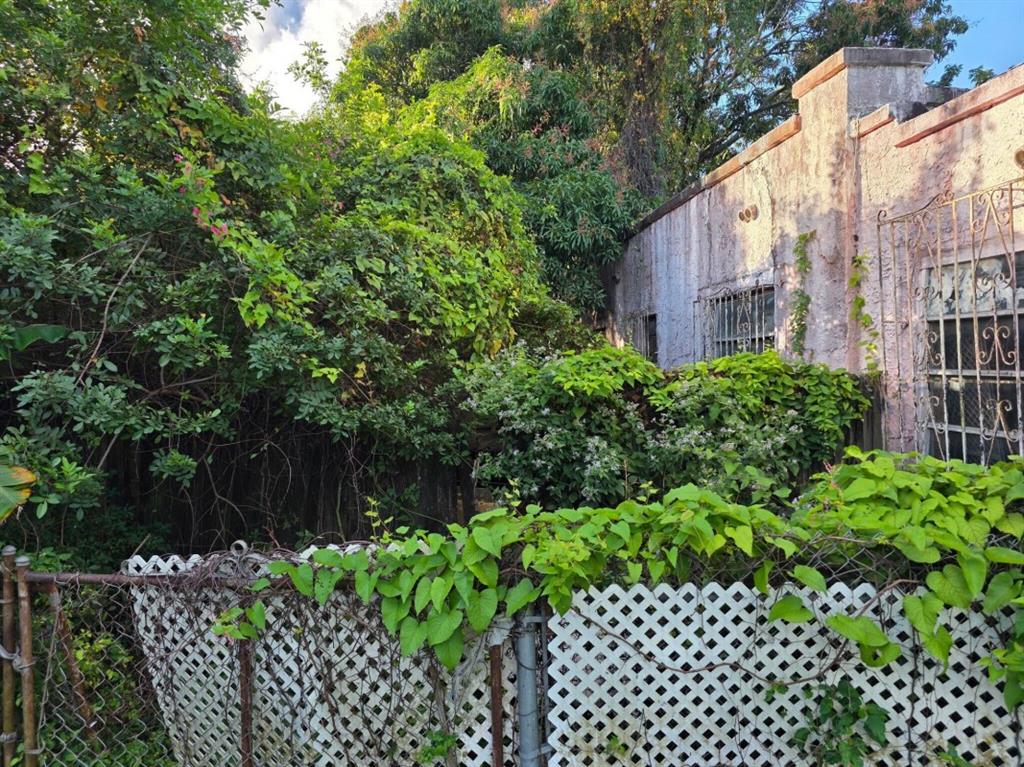 660 Northwest 43rd Street Miami, FL 33127 - Photo 3 of 5 a couple of flower plants in front of house