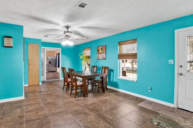 a view of a livingroom with furniture and a window