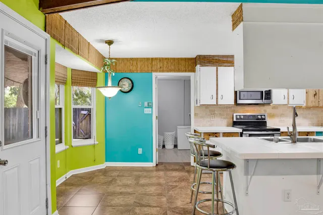 a kitchen with stainless steel appliances a stove a refrigerator and cabinets