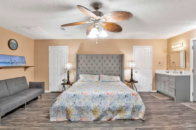 a bedroom with a large bed chandelier and a window