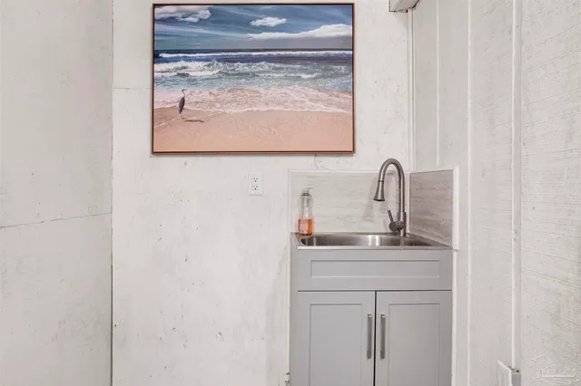 a bedroom with a bed a chandelier and a mirror