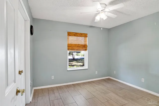 a view of a big room with windows and fan