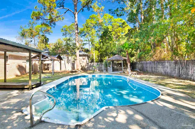 a view of a backyard with wooden fence