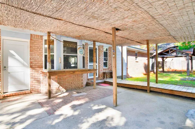 a view of a house with backyard and sitting area