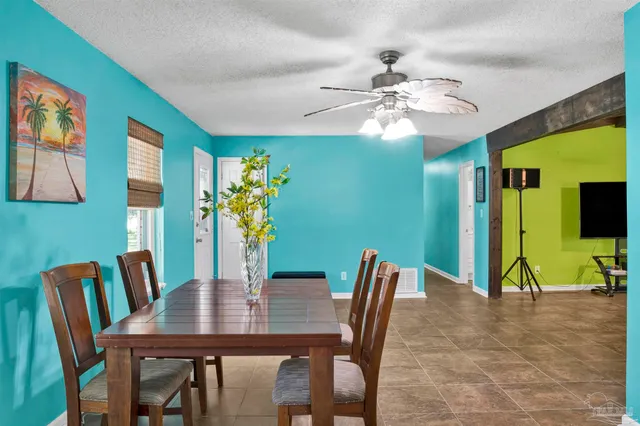 a view of a dining room with furniture and a flat screen tv