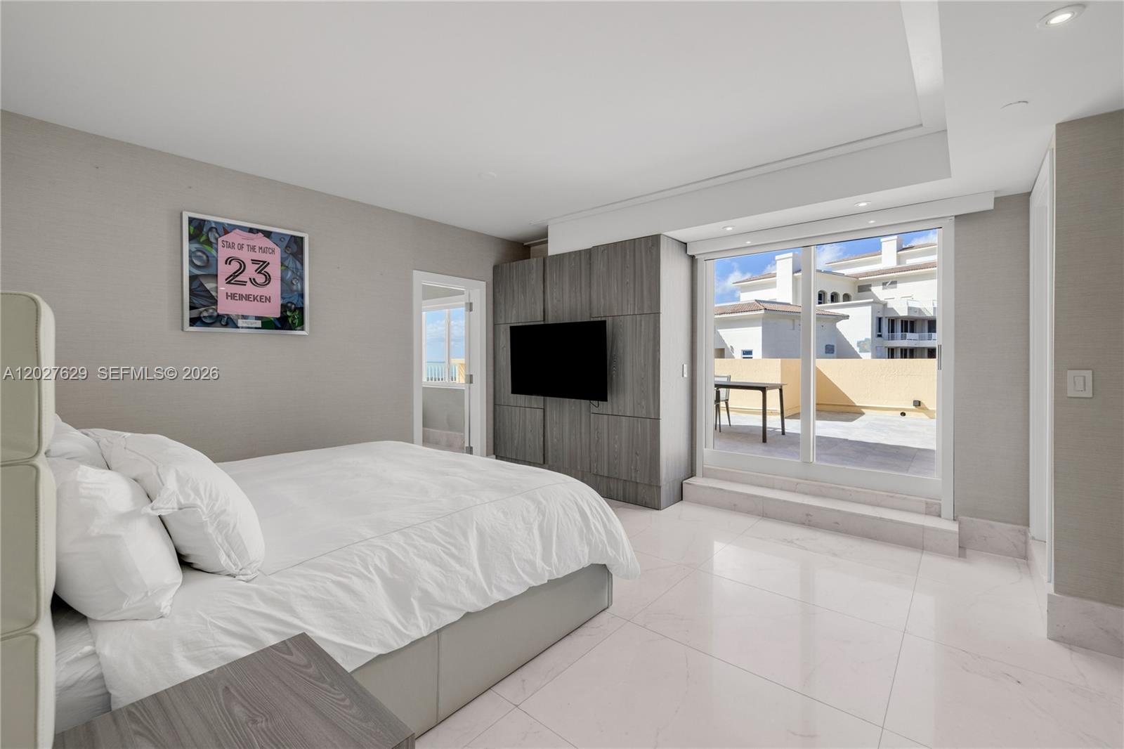 799 Crandon Boulevard, Unit PH8 Key Biscayne, FL 33149 - Photo 22 of 47 a bedroom with a large bed and a flat screen tv