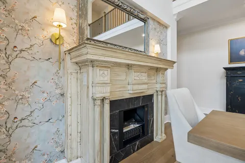 a living room with furniture fireplace and a large window