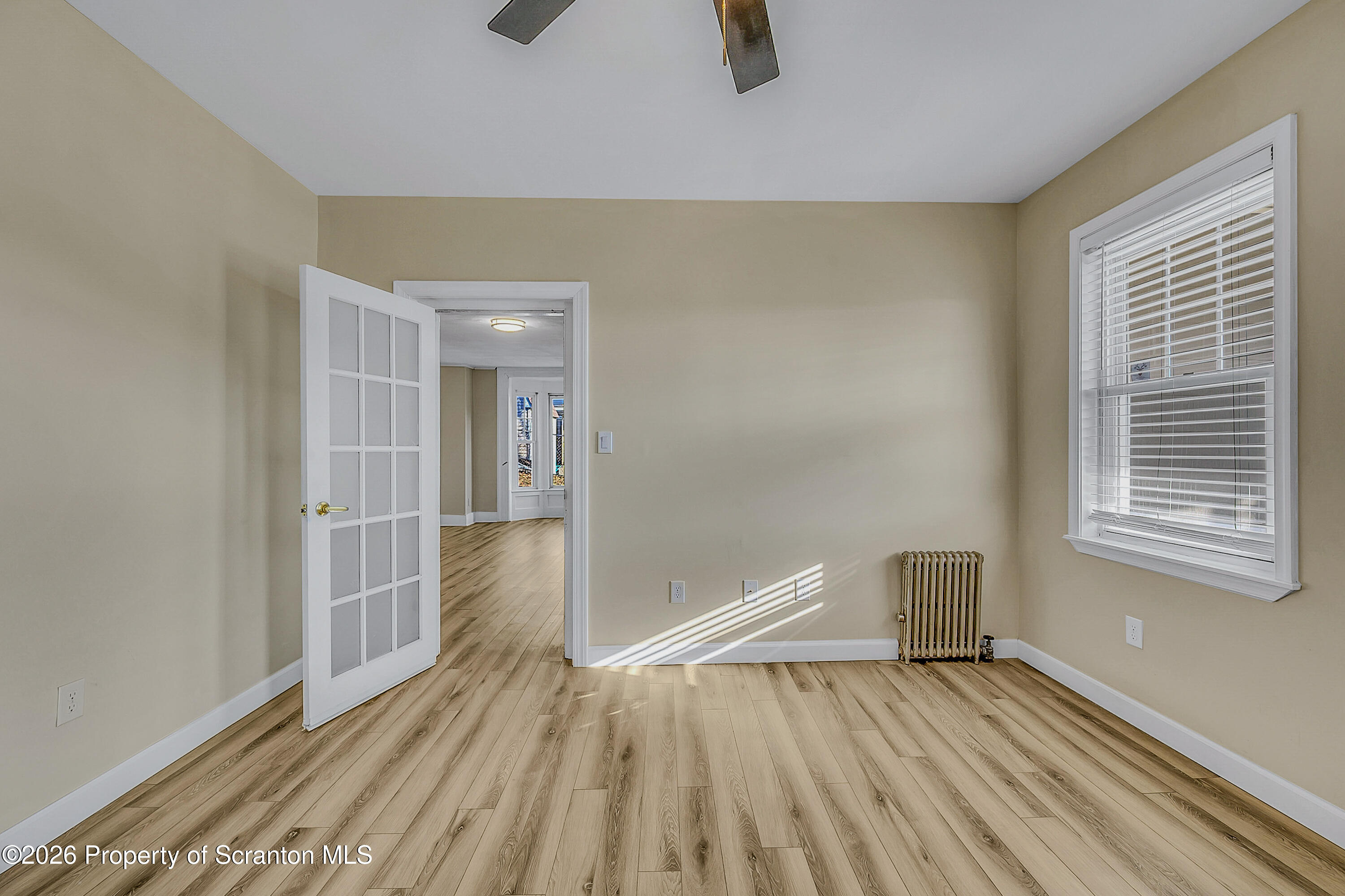 331 Cherry Street, Unit A Dunmore, PA 18512 - Photo 15 of 18 a view of empty room with wooden floor and fan