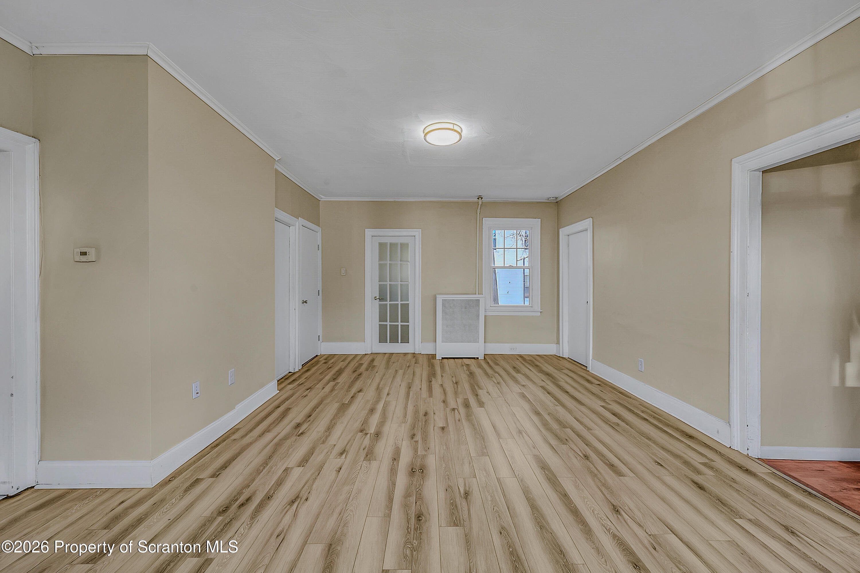 331 Cherry Street, Unit A Dunmore, PA 18512 - Photo 9 of 18 a view of an empty room with wooden floor and window