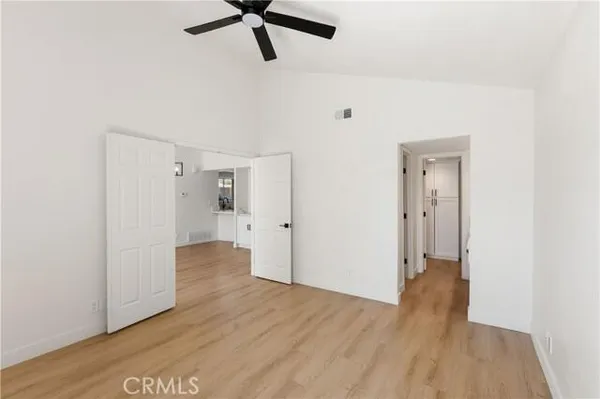 a view of a room with wooden floor and white walls