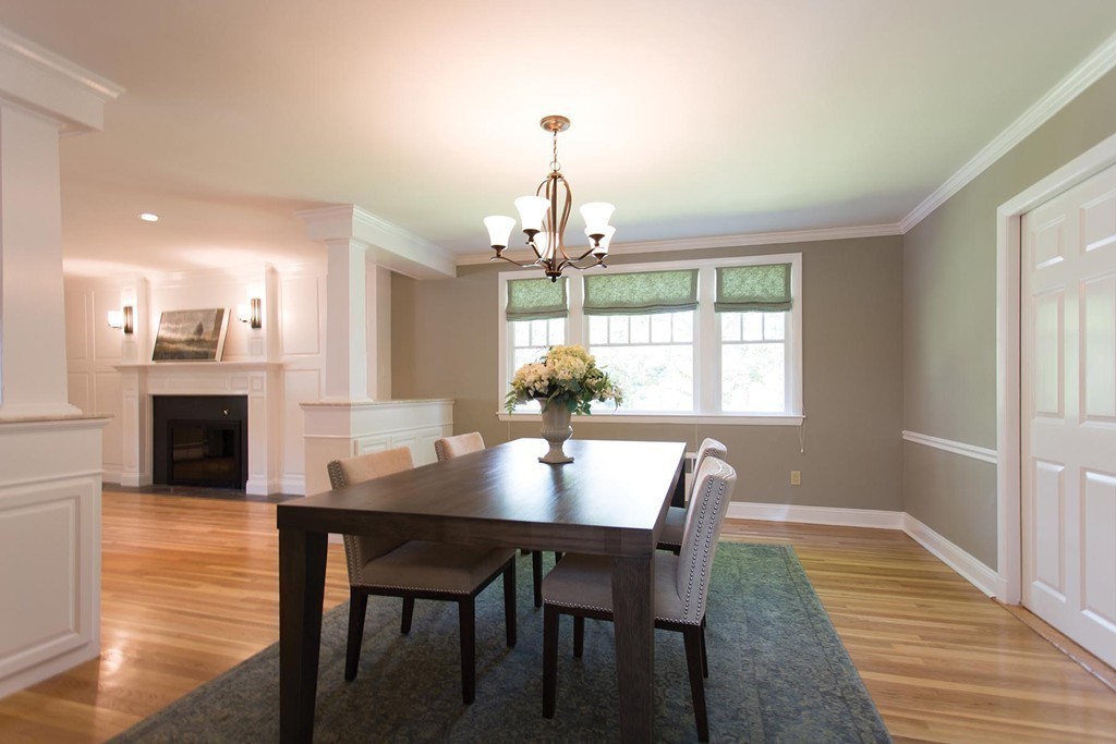 63 Suffolk Road Wellesley, MA 02481 - Photo 6 of 24 a dining room with wooden floor a chandelier a wooden table and chairs