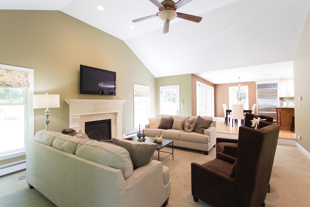63 Suffolk Road Wellesley, MA 02481 - Photo 7 of 24 a living room with furniture a flat screen tv and a fireplace