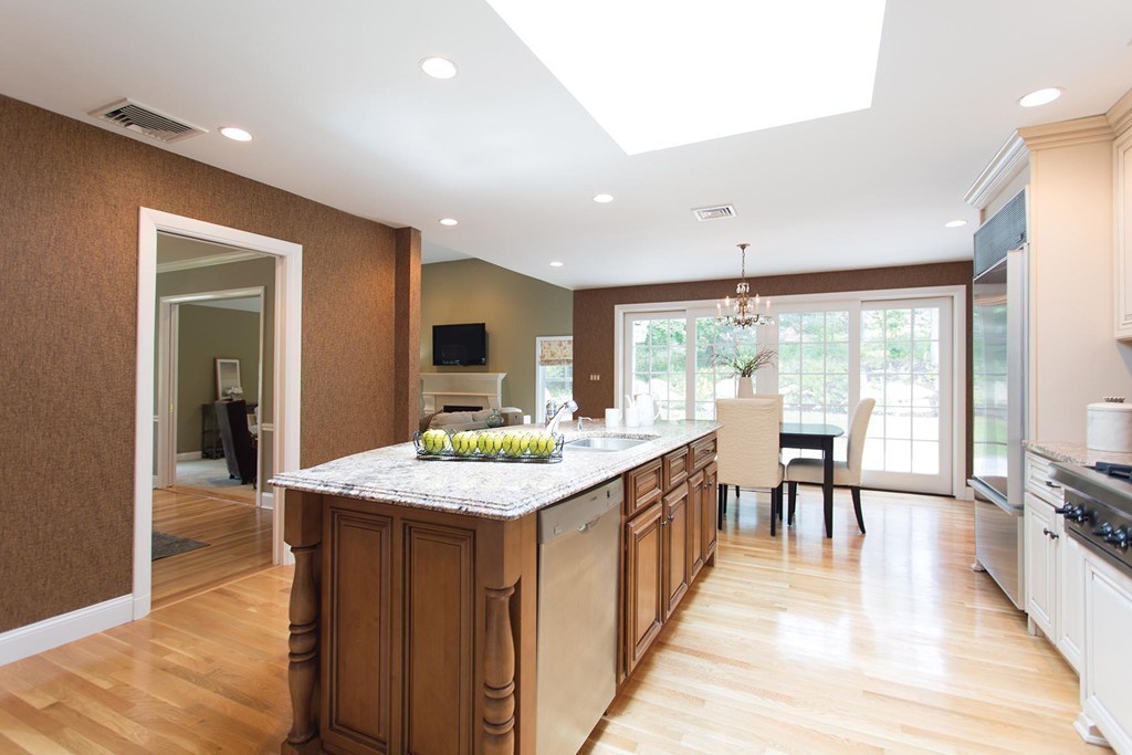 63 Suffolk Road Wellesley, MA 02481 - Photo 8 of 24 a large kitchen with kitchen island a sink table and chairs