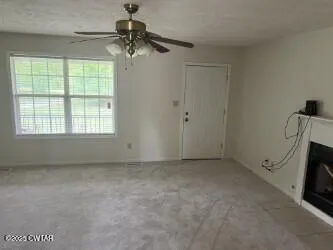 a view of empty room with ceiling fan