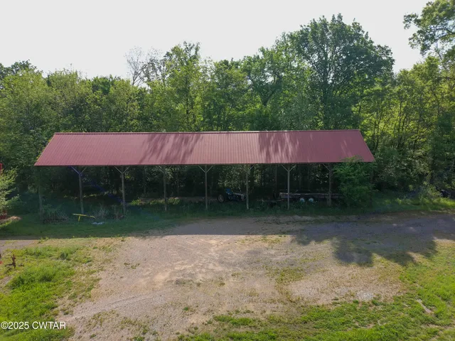 a backyard of a house with yard and outdoor seating
