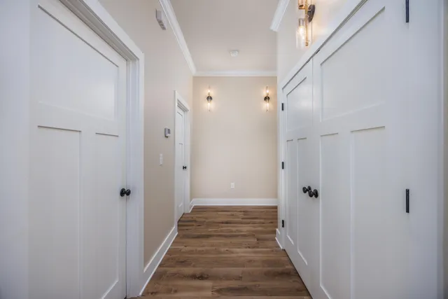 a view of a hallway with a wooden door