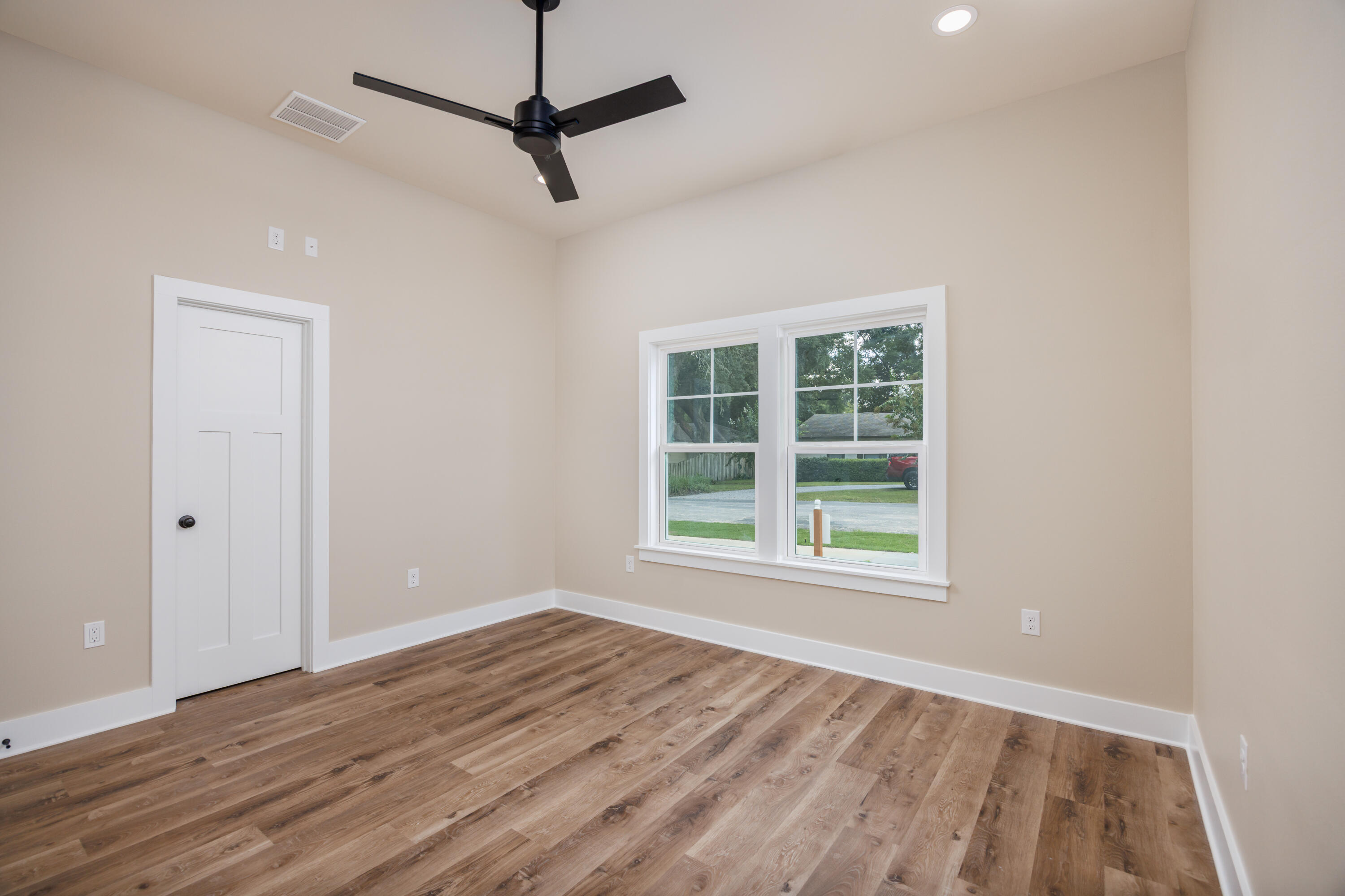 14 Shebbi Lane Freeport, FL 32439 - Photo 16 of 25 a view of an empty room with wooden floor and a window