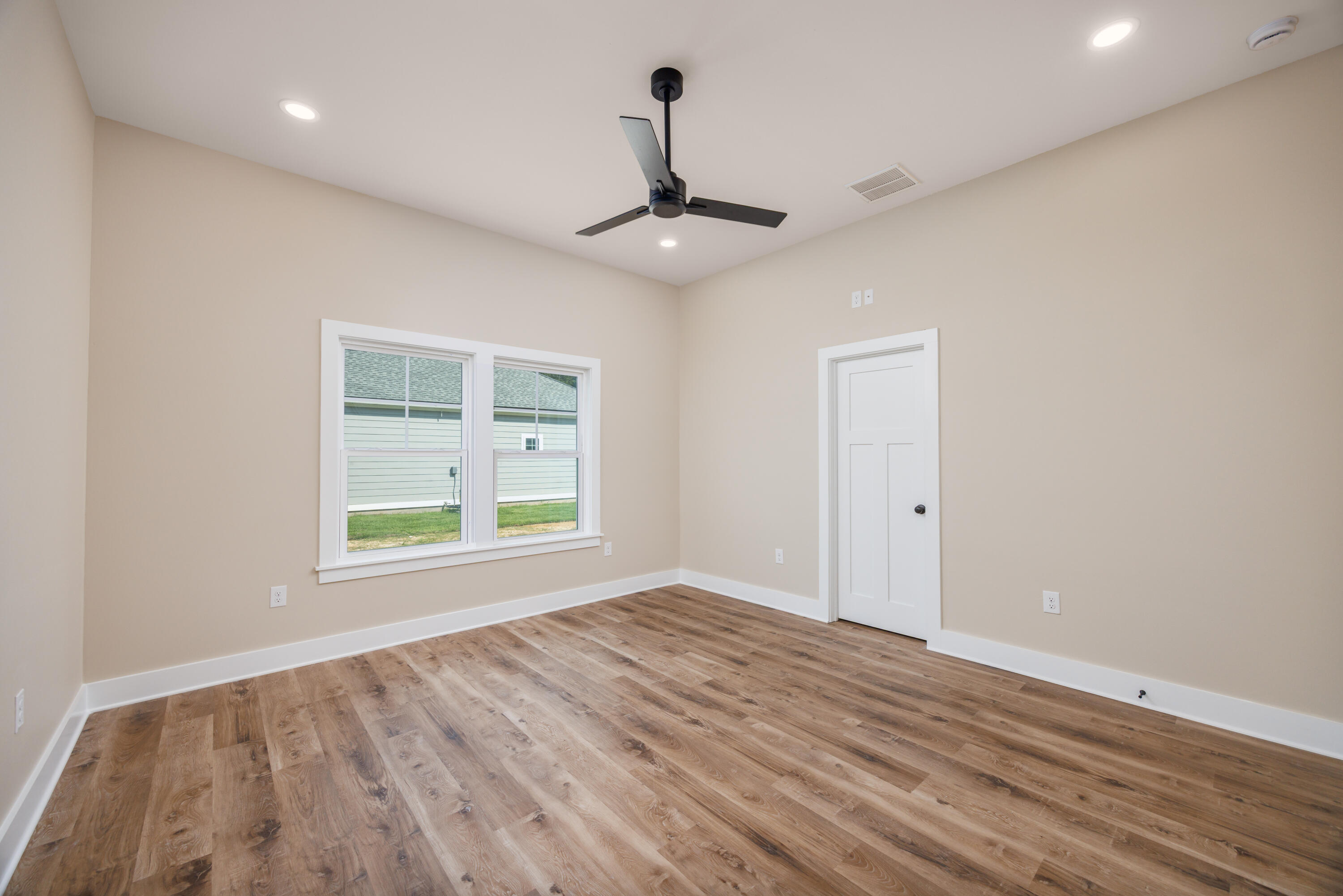 14 Shebbi Lane Freeport, FL 32439 - Photo 17 of 25 a view of an empty room with window and wooden floor