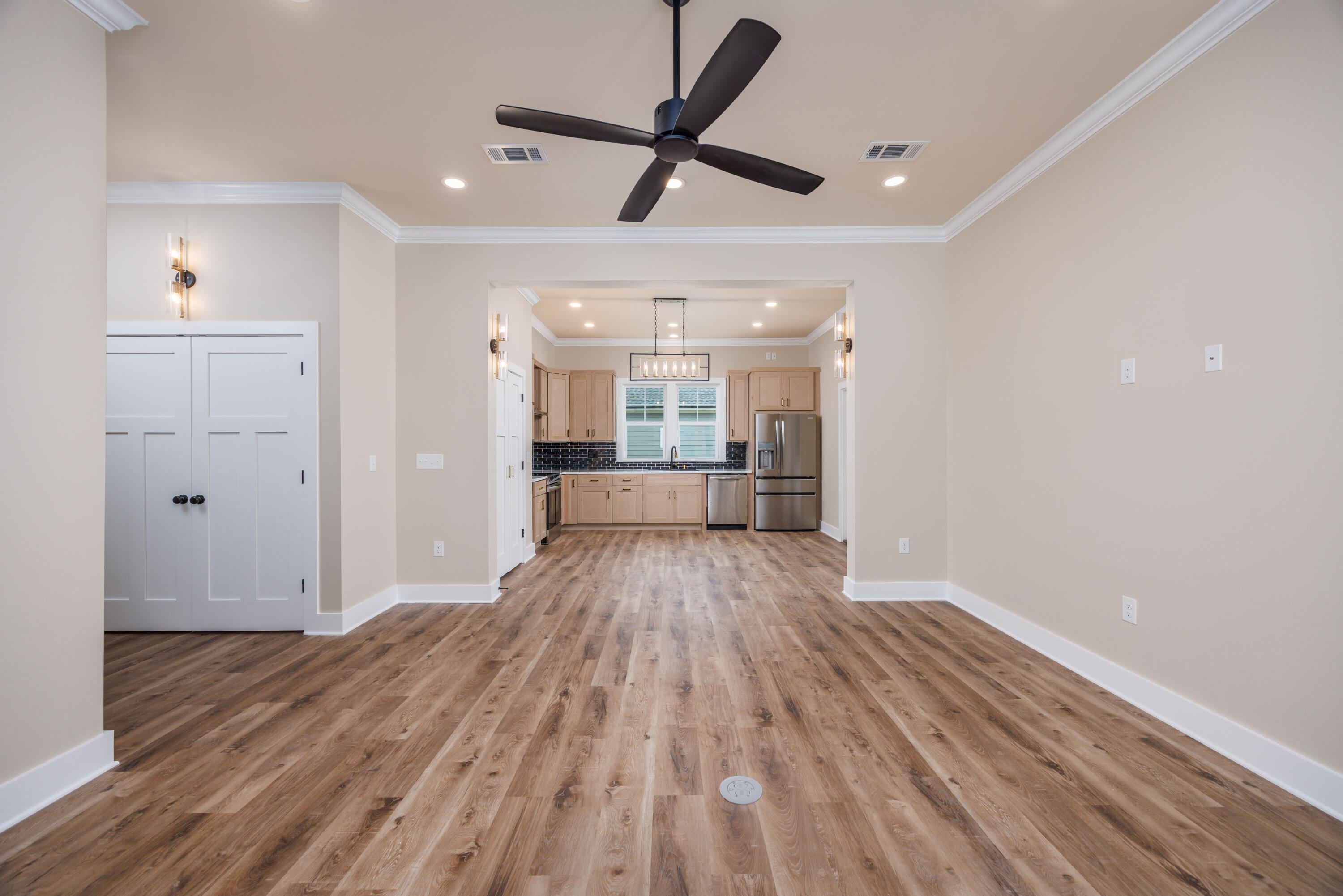 14 Shebbi Lane Freeport, FL 32439 - Photo 5 of 25 a view of a big room with wooden floor a ceiling fan and windows
