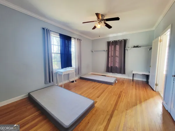 a room with pool table and a ceiling fan