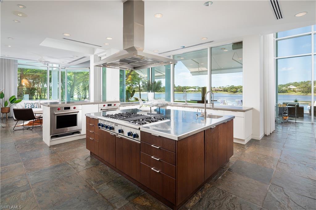 427 Ridge Court Naples, FL 34108 - Photo 11 of 49 a large kitchen with stainless steel appliances granite countertop a sink and cabinets