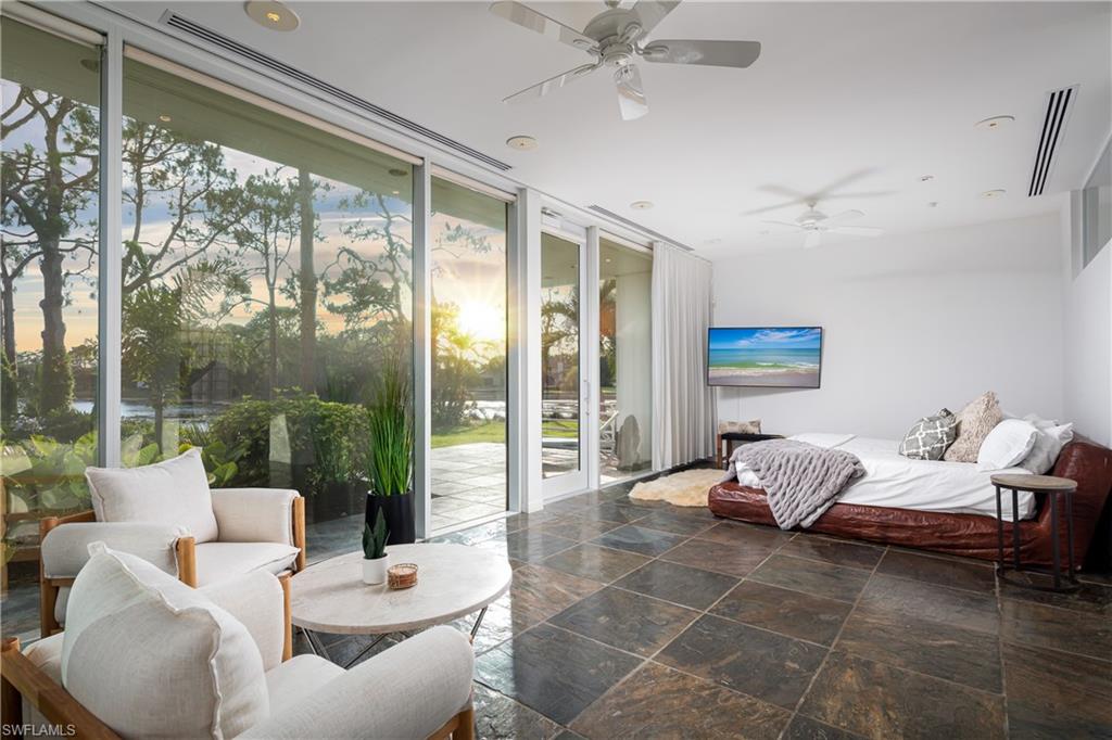 427 Ridge Court Naples, FL 34108 - Photo 15 of 49 a living room with furniture and a floor to ceiling window