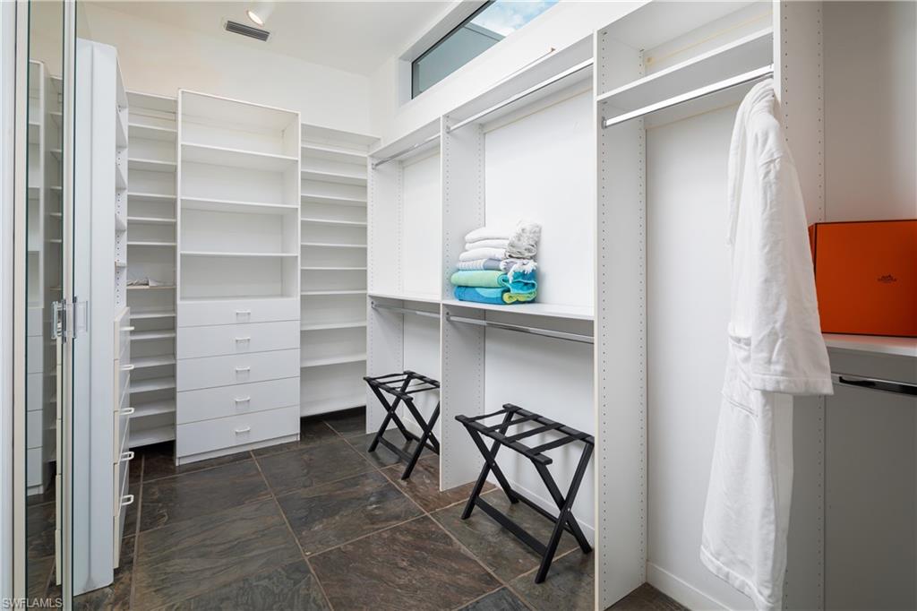 427 Ridge Court Naples, FL 34108 - Photo 17 of 49 a view of walk in closet with empty racks