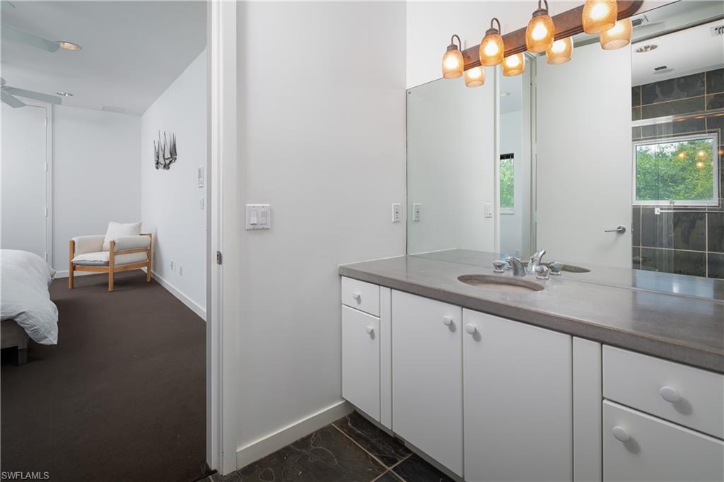 427 Ridge Court Naples, FL 34108 - Photo 19 of 49 a bathroom with a sink a light fixture and a mirror