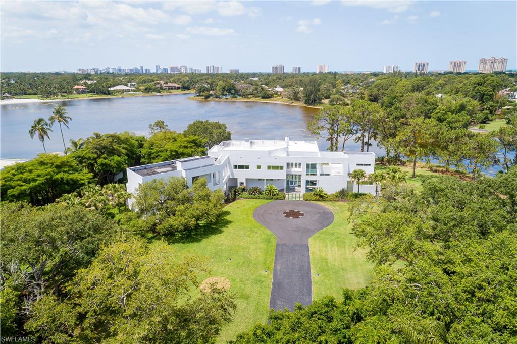 427 Ridge Court Naples, FL 34108 - Photo 2 of 49 a view of a lake with a city