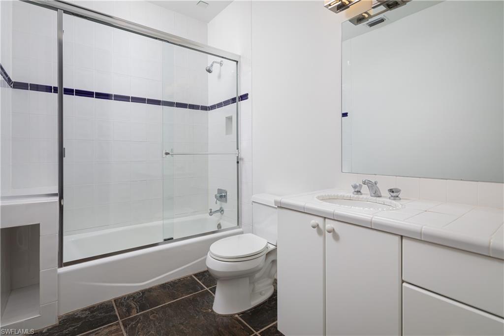 427 Ridge Court Naples, FL 34108 - Photo 23 of 49 a bathroom with a granite countertop sink toilet and shower