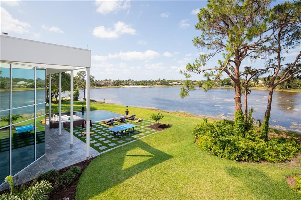 427 Ridge Court Naples, FL 34108 - Photo 27 of 49 a view of a swimming pool with a lounge chairs