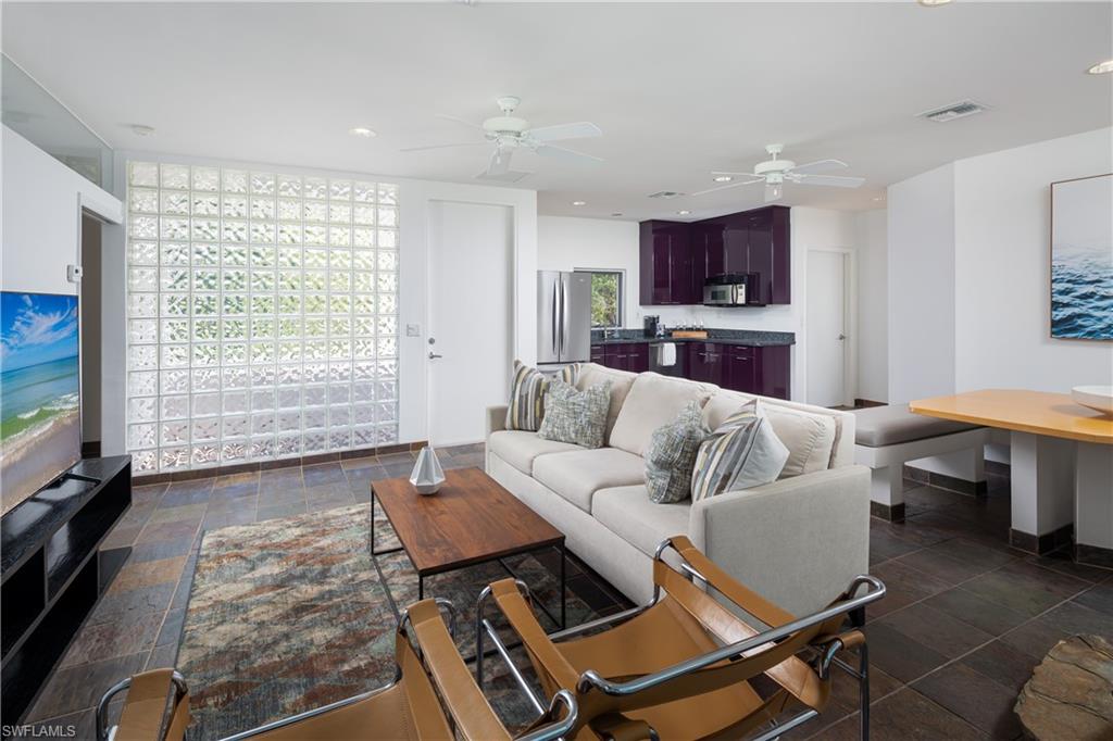 427 Ridge Court Naples, FL 34108 - Photo 29 of 49 a living room with furniture a flat screen tv and a large window