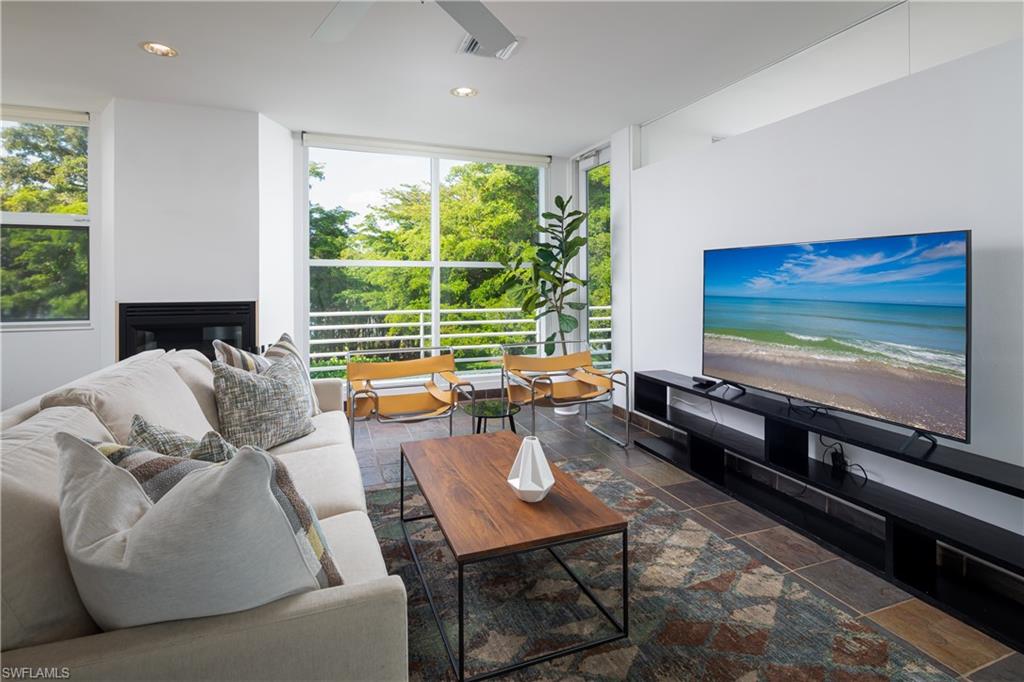 427 Ridge Court Naples, FL 34108 - Photo 30 of 49 a living room with furniture flat screen tv and a large window