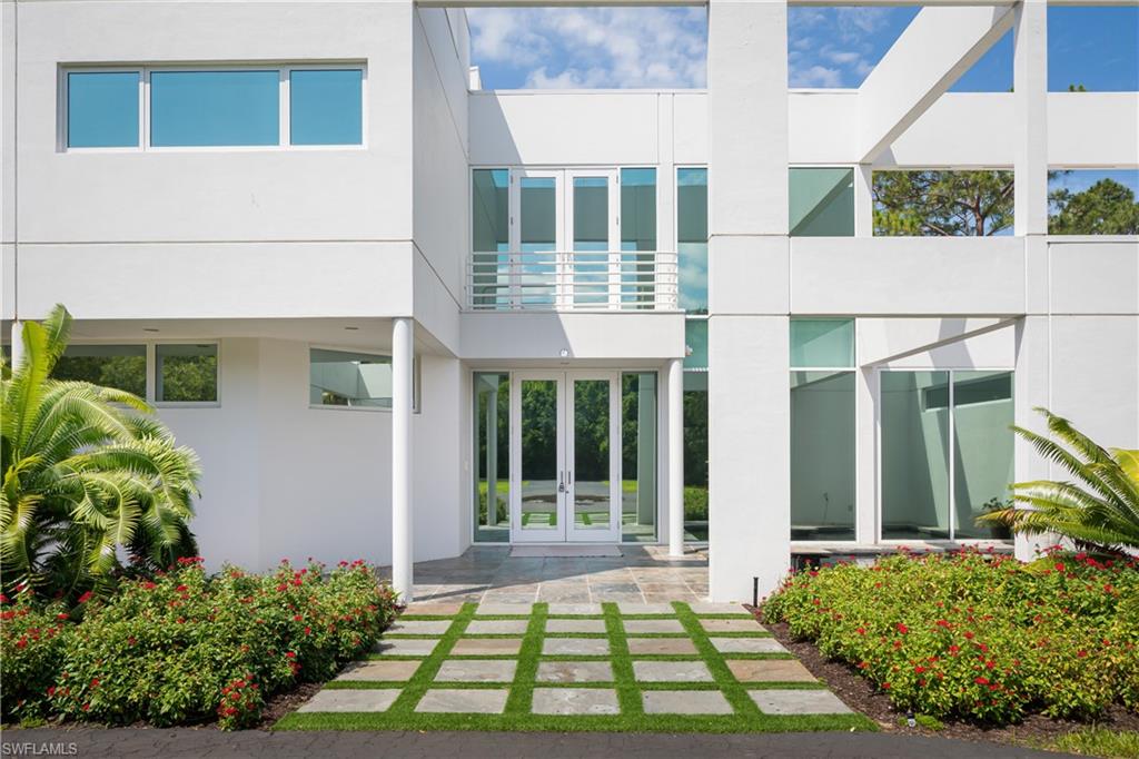 427 Ridge Court Naples, FL 34108 - Photo 3 of 49 a front view of a house with a yard