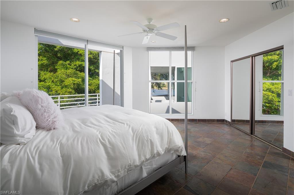 427 Ridge Court Naples, FL 34108 - Photo 31 of 49 a bed sitting in a spacious bedroom next to a window