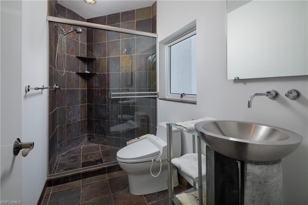 427 Ridge Court Naples, FL 34108 - Photo 32 of 49 a bathroom with a sink toilet and shower