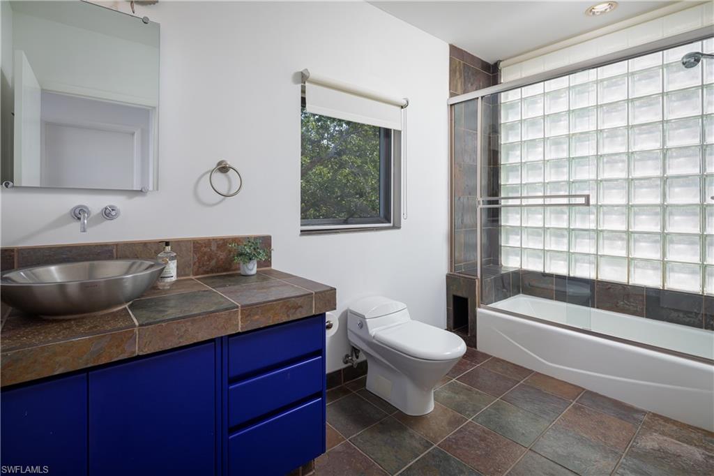 427 Ridge Court Naples, FL 34108 - Photo 34 of 49 a bathroom with a granite countertop sink a toilet and bathtub